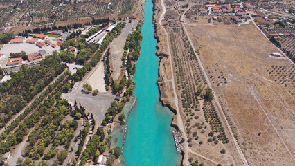 Aerial drone photo of yacht crossing narrow Corinth canal of Isthmus from West submersible bridge...