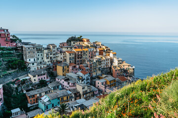 Aerial view of Manarola,Cinque Terre,Italy.UNESCO Heritage Site.Picturesque colorful village on rock above sea.Summer holiday,travel background.Italian Riviera landscape.Houses on steep cliff