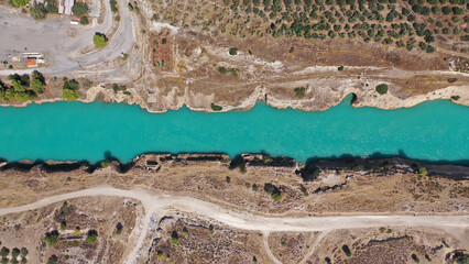 Aerial drone photo of yacht crossing narrow Corinth canal of Isthmus from West submersible bridge...