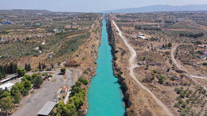 Aerial drone photo of yacht crossing narrow Corinth canal of Isthmus from West submersible bridge...