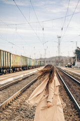 Fototapeta premium woman on railway station with a retro suitcase