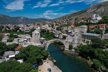 Fantastic Skyline of Mostar with the Mostar Bridge, houses and minarets, during sunny day. Mostar,...