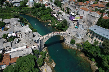 Fantastic Skyline of Mostar with the Mostar Bridge, houses and minarets, during sunny day. Mostar,...