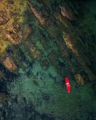 Vertical drone view of a kayaker in the sea near Skiathos island, Greece