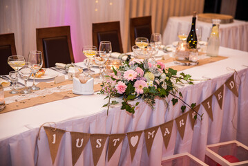 Wedding table setting with just married decor and flowers