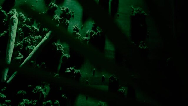 Drugs and marijuana, sbd or thc bumps. Sativa and indica in green neon. Weed and smoking plants, laboratory. Grinder and joints with pipe.