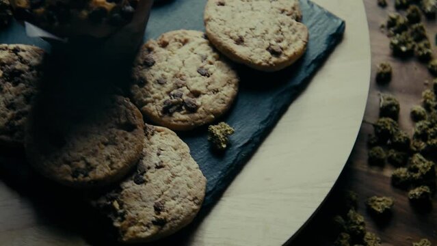 Marijuana cookie, dope cupcake, cbd thc cookie. Marijuana buds. indica and sativa. drugs in food, thc and cbd brownies. Sweet on the background of marijuana.