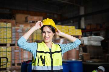 Portrait of a Happy warehouse worker in a warehouse or storehouse while looking at camera.