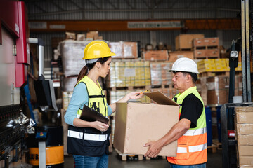 Warehouse worker checking the quantity of storage products  in the warehouse., Industrial and...