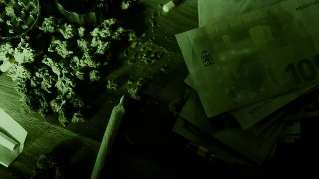 Male hands clog a bong with marijuana. A man smokes weed through a bong. Neon green light. CBD treatment. Medicine and drugs.