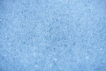 Fototapeta na wymiar Frosty pattern on frozen ice, hoarfrost on lake ice, winter abstract background
