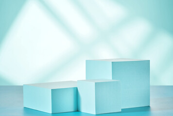 Blue podiums for product presentation on a blue background