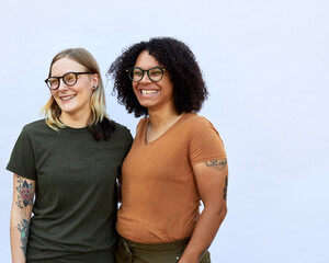 Portait of Female LGBTQ+ Couple Smiling off camera on white background