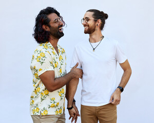 Portrait of Male LGBTQ+ couple laughing on a white background