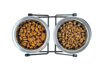 Dry food for cats and dogs in metal bowls isolated on a white background. Top view.