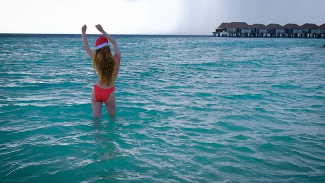 Woman From A Back With A Long Hair And Red Bikini.