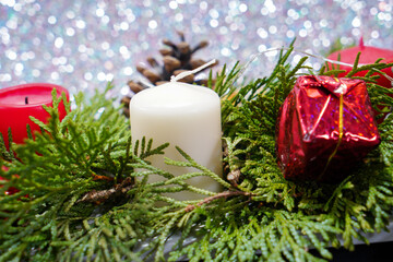 Christmas with red candles and christmas tree balls and fir branches and pine cones