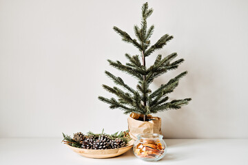 Sustainable Eco friendly zero waste Christmas. Natural Zero waste sustainable Xmas Tree Ornament Hanging Decorations. Christmas Tree and dry orange Slices, snow Pine Cones Ornament on table