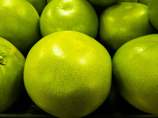 Pomelo fruit on display at a grocery store