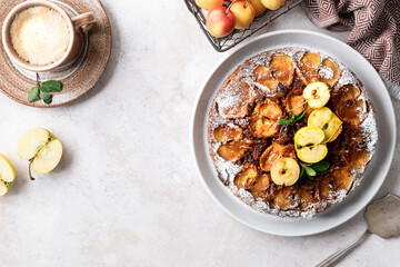 French sweet tarte tatin apple pie upside down and fresh red apple.