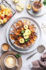 French sweet tarte tatin apple pie upside down and fresh red apple. Vertical