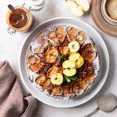 French sweet tarte tatin apple pie upside down and fresh red apple. Square