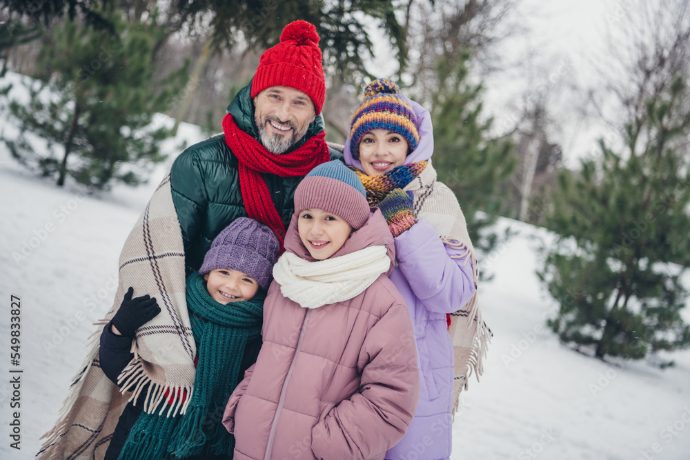 Sticker Photo of charming pretty husband wife small kids wear windbreakers cuddling under warm blanket together outside urban city park