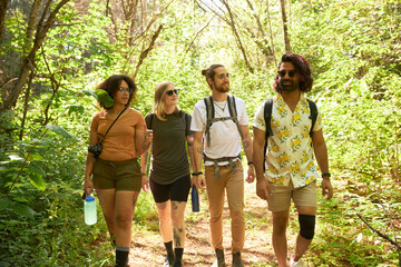 Four LGTBTQ+ Friends walking on Nature Hike in forest