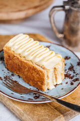 French dessert called Mille Feuille or Napoleon cake on rustic wooden board. Layered tasty cake with vanilla cream and puff pastry.