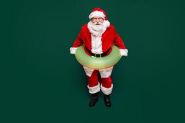 Christmastime December festive night. Full legs body size positive handsome glad aged mature grandfather Nicholas with white beard isolated red bright background look at camera make beaming smile