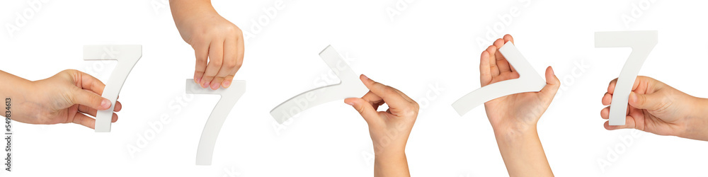 Poster number seven in hand isolated on black background. number 7 in a child's hand is held on a black bac