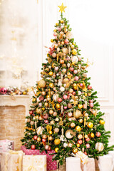 A large beautiful traditional Christmas tree with gifts in a classic interior.