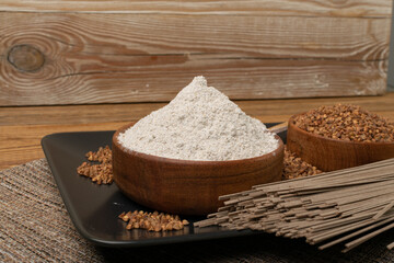 Buckwheat Flour Pile in Wood Bowl, Dry Buck Wheat Powder, Buckwheat Flour on Wooden Rustic Background