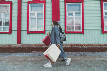 Happy female friends shopping. Two beautiful young women enjoying shopping in city with shopping bags copy space - consumerism and friendship concept