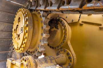 Close up of sprocket and track of construction bulldozer