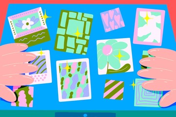 Caucasian hands arranging the colorful and childish drawings on a blue desk