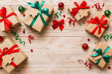 Holiday flat lay with gift boxes wrapped in colorful paper and tied decorated with confetti on colored background. Christmas, Birthday, Valentine and sale concept, top view