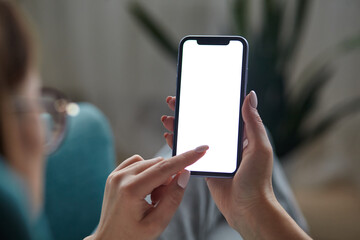 Woman hand holding using touch mobile phone white screen mockup Back view