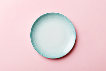 Top view of isolated of colored background empty round blue plate for food. Empty dish with space for your design