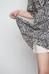 Serie of studio photos of young female model in zebra print mini dress