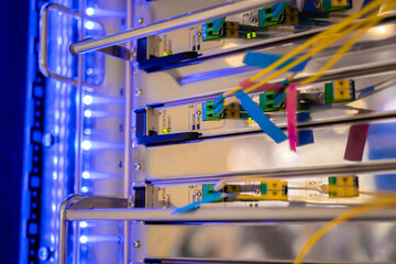 Telecommunication technology equipment - fiber optic cables and switch at server room, data center - close up. Network, transfer, traffic, web, hardware, connection and internet concept