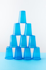 Pyramid of blue plastic cups. Set for party.