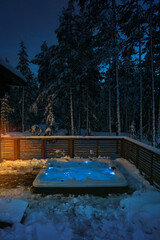 Warm hot tub invites you to relax in a beautiful winter landscape under the stars.
