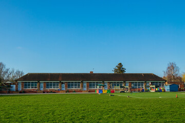 British Junior school playground & infant school playing fields on a sunny day