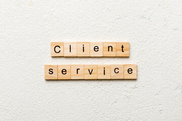 Client service word written on wood block. Client service text on cement table for your desing, concept