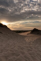 Vertical shot of a sandy beach of Cape Cod, Massachusetts surrounded by mountains