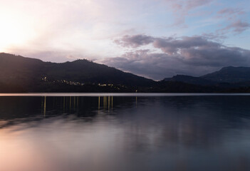 Colombian Gachala town viewed from guavio reservoir in colorful sunset