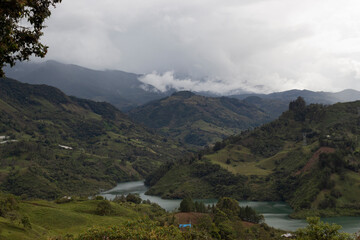 Fototapeta na wymiar Beautiful cloudy mountains landscape of colombian guavio region 