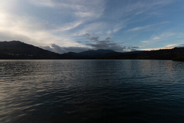 Beautiful blue sunset on colombian guavio dam lake and andean mountains silhouette