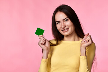 woman in yellow clothes holding plastic credit card
